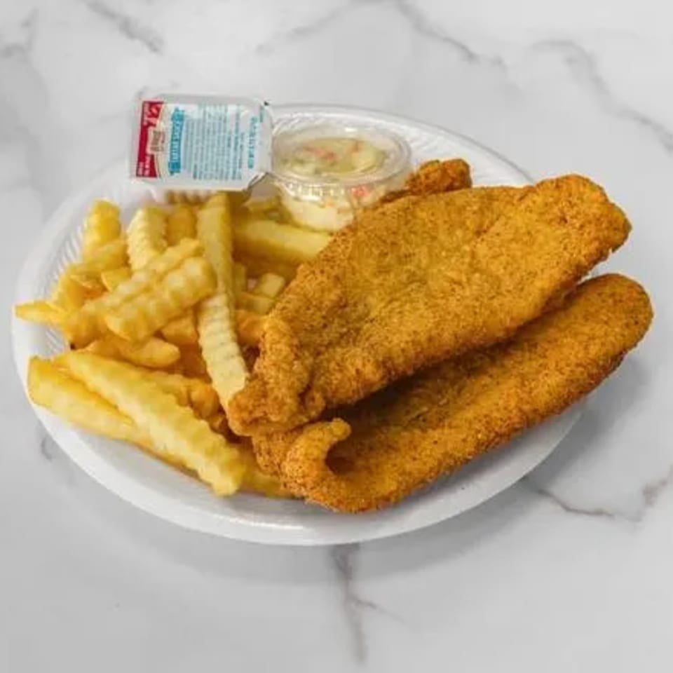 Fried fish fillets with crinkle-cut fries, coleslaw, and tartar sauce on a white plate.
