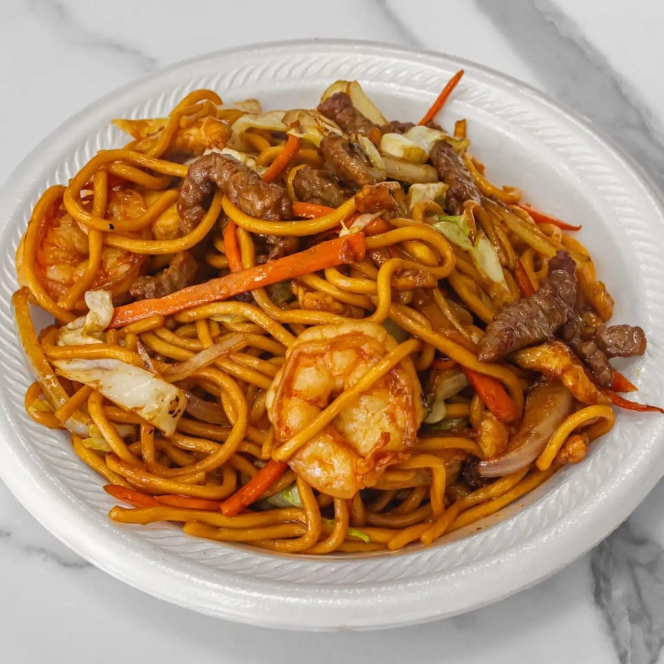 A close-up of Aaron Wings & Hibachi's hibachi noodles with shrimp, beef, and vegetables.